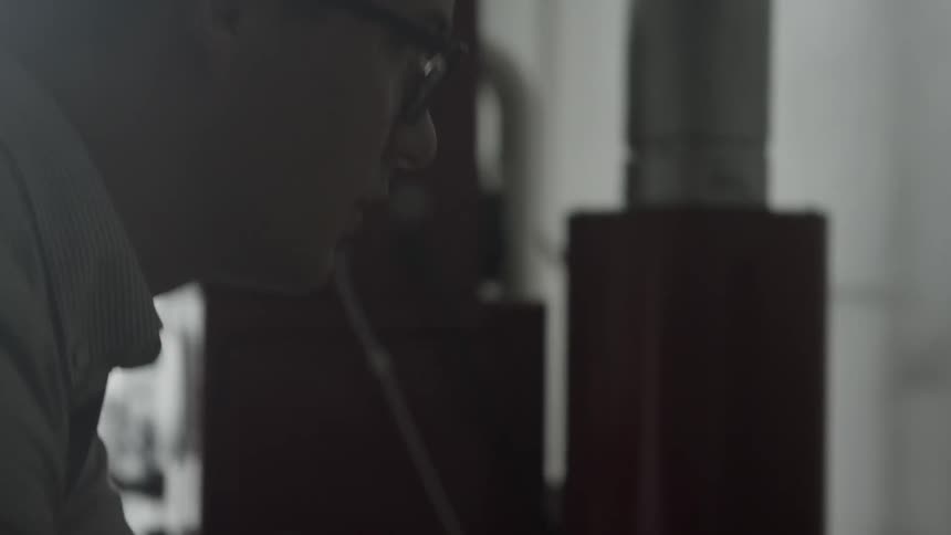 A man looks forward at a computer