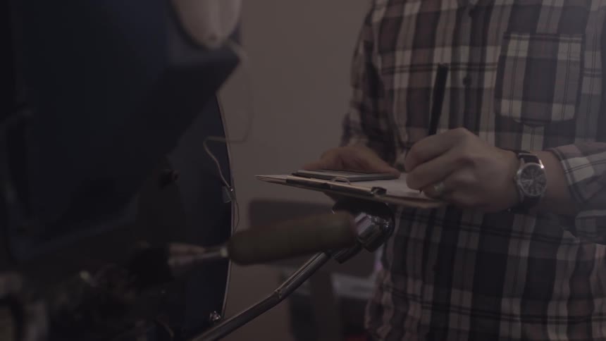 A man is taking notes on a notepad