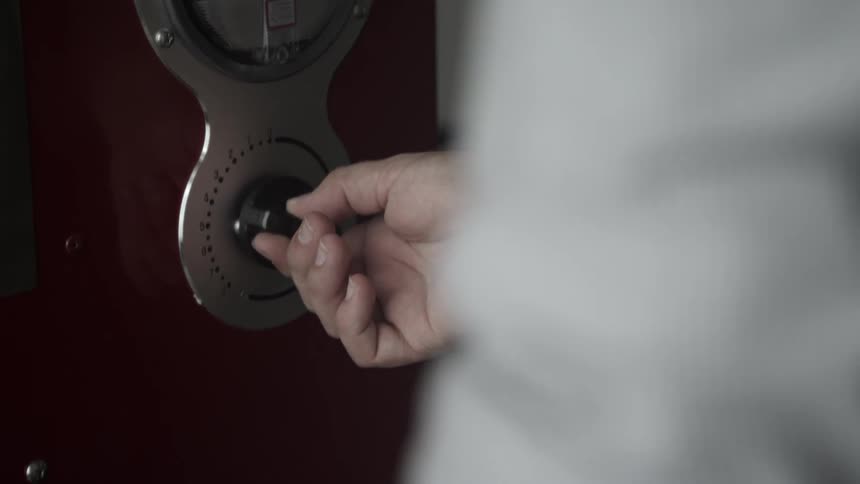 A person turns the dial on a radio
