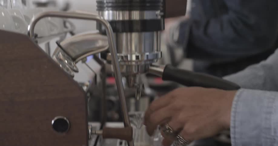 Two men prepare coffee drinks