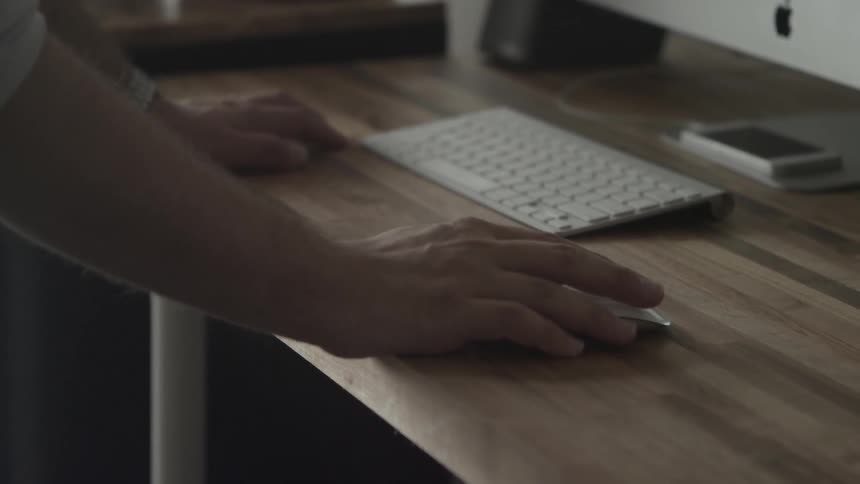 A man uses a computer and mouse