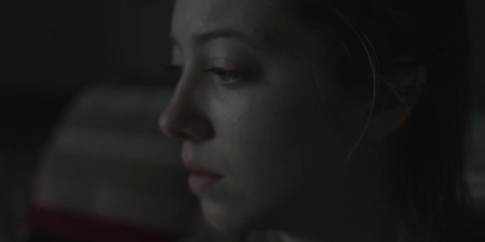 A woman looks around blinking
