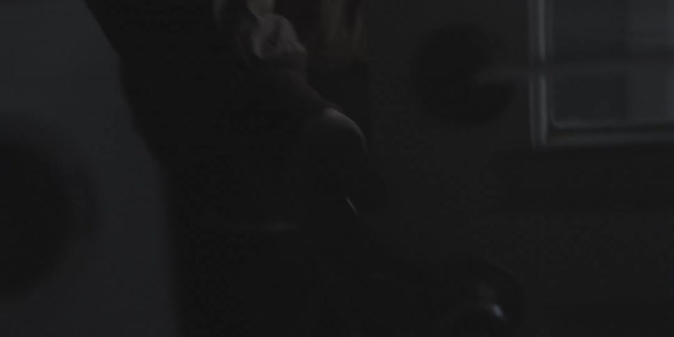 Man walks through a dark house and opens the door