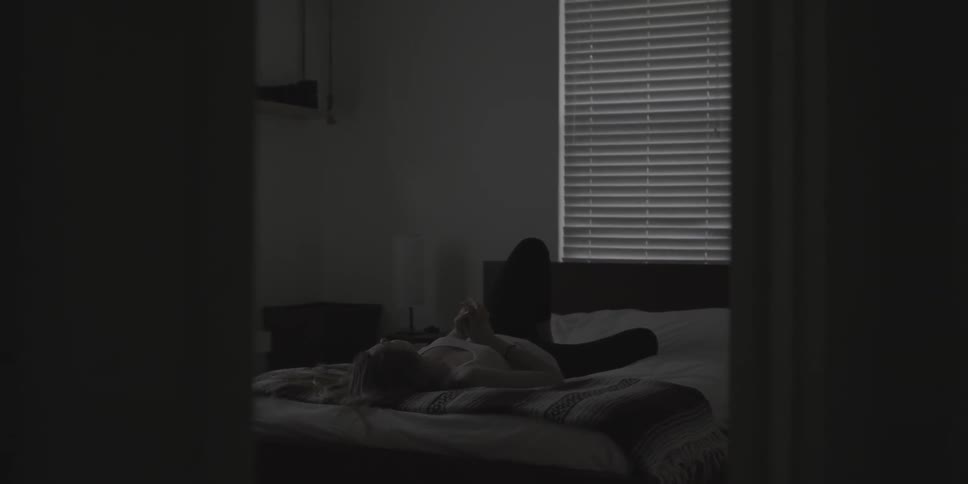 Person laying down on a bed