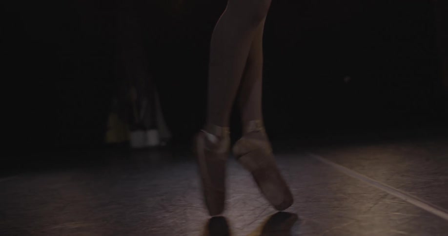 Close up of person's feet and legs dancing a ballet routine