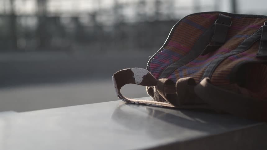 A purse outside on a ledge