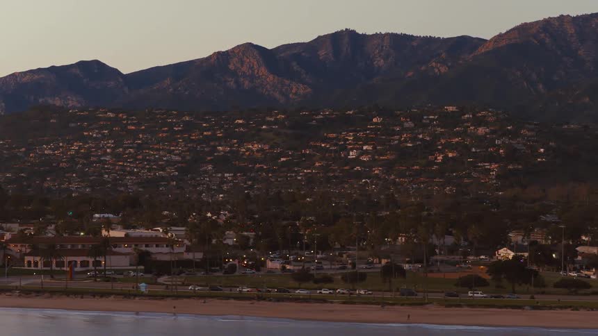 A slow pan reveals the stunning Santa Barbara coastline with the Santa Ynez Mountains in the background at sunset