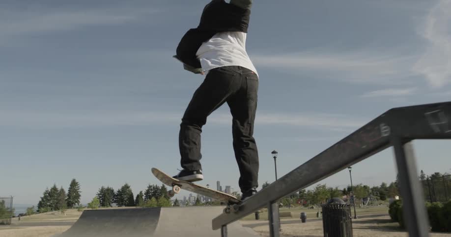 Skateboarder rides up a ramp in a skate park