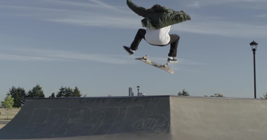 Man trying to do trick on skateboard off ramp but failing
