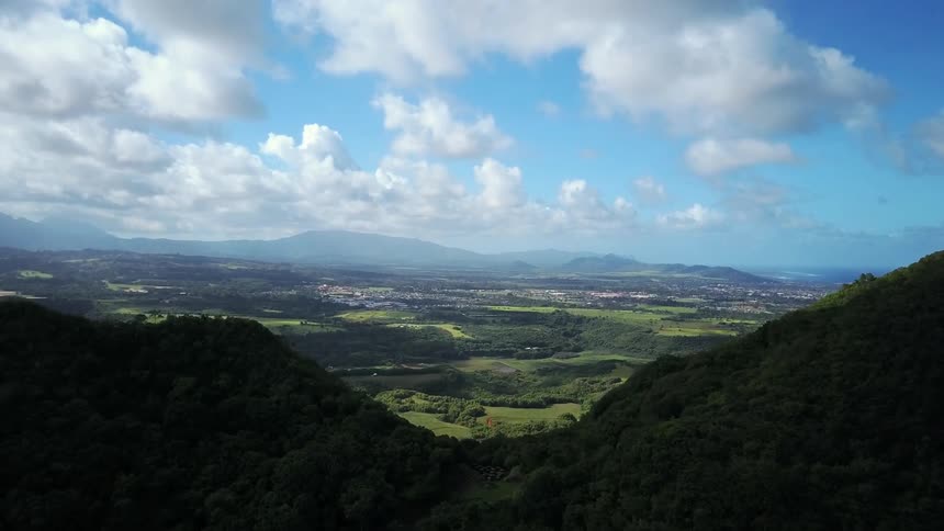 Clouds float over a valley