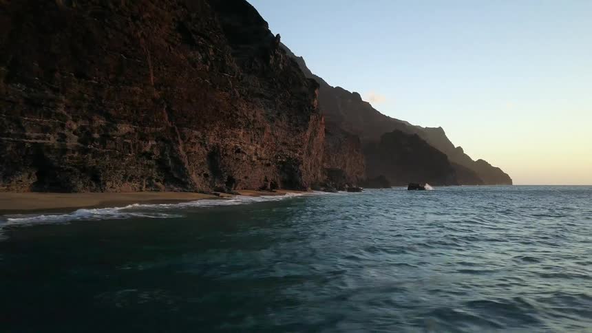 Ocean waves flow towards a sandy beach