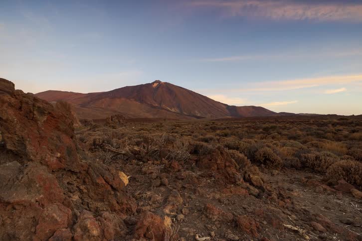 A majestic sunrise timelapse illuminates the volcanic peak of Mount Teide as light moves across the rocky landscape