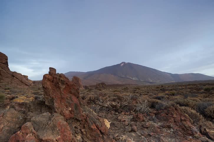A striking timelapse captures the majestic Mount Teide from a barren volcanic landscape with unique rock formations as clouds drift across the sky