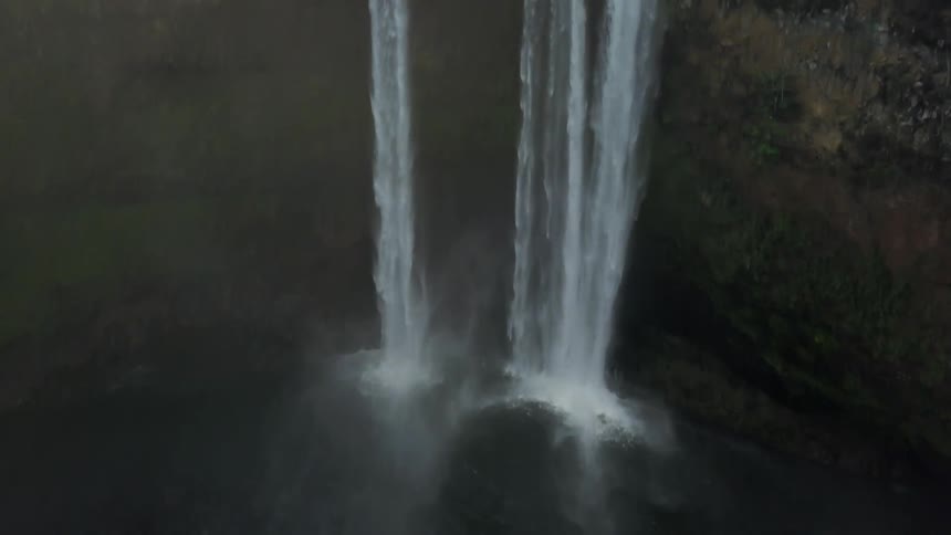 Waterfalls cascade over a cliff