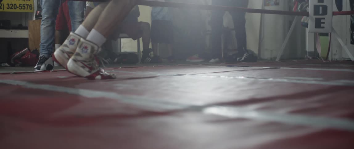 Man's feet in a boxing ring