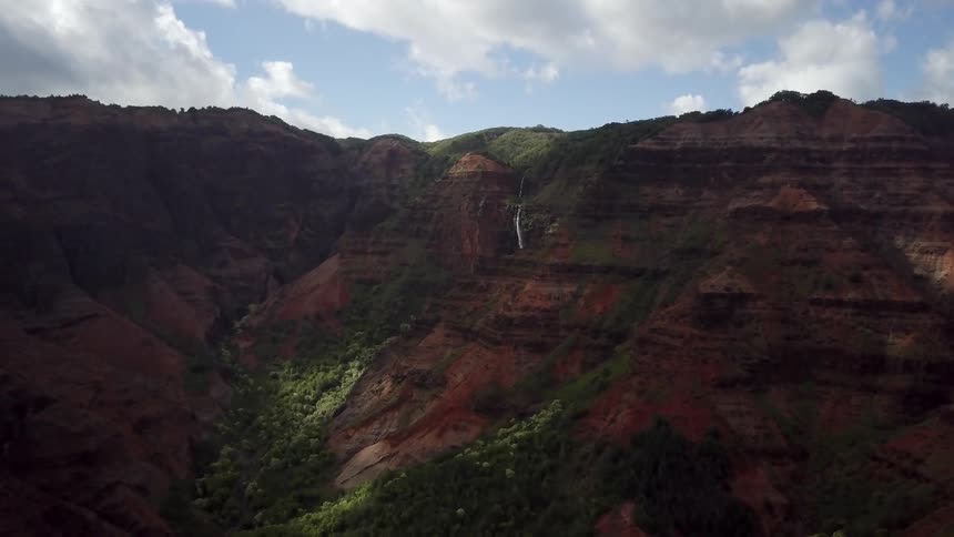 Clouds float over a rocky canyon