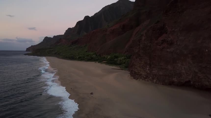 Ocean waves wash ashore a sandy beach