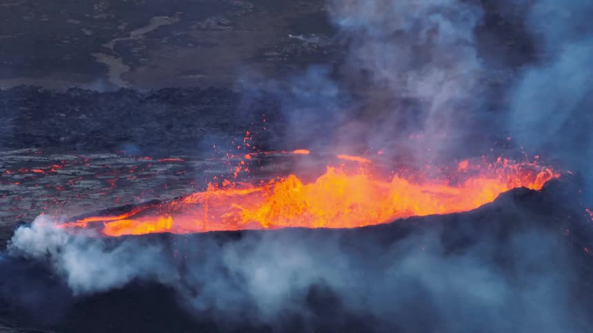 A powerful slow-motion shot of a volcanic fissure erupting, spewing fiery molten lava and smoke into the air