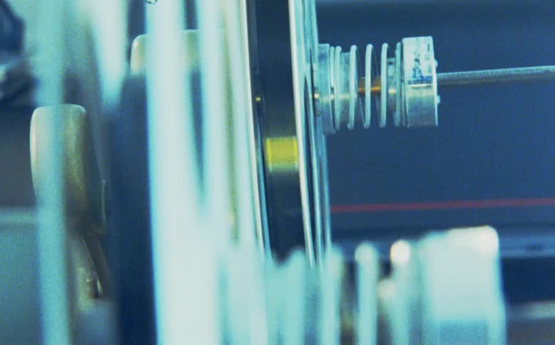 Close-up detail of a vintage film reel spinning on a projector