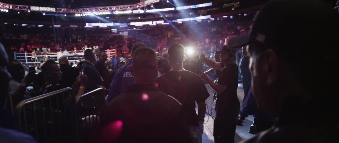 Boxer walking through the audience and approaching the ring at a boxing match