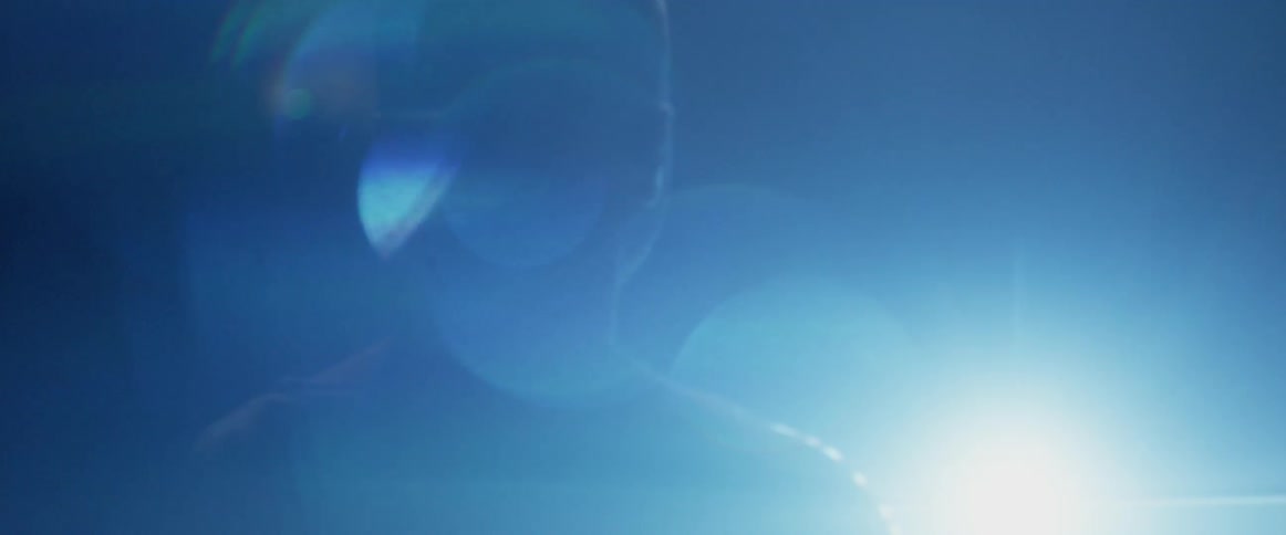A bright light shines between two men