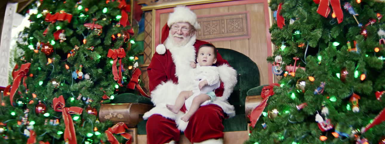Santa holds a baby on his lab