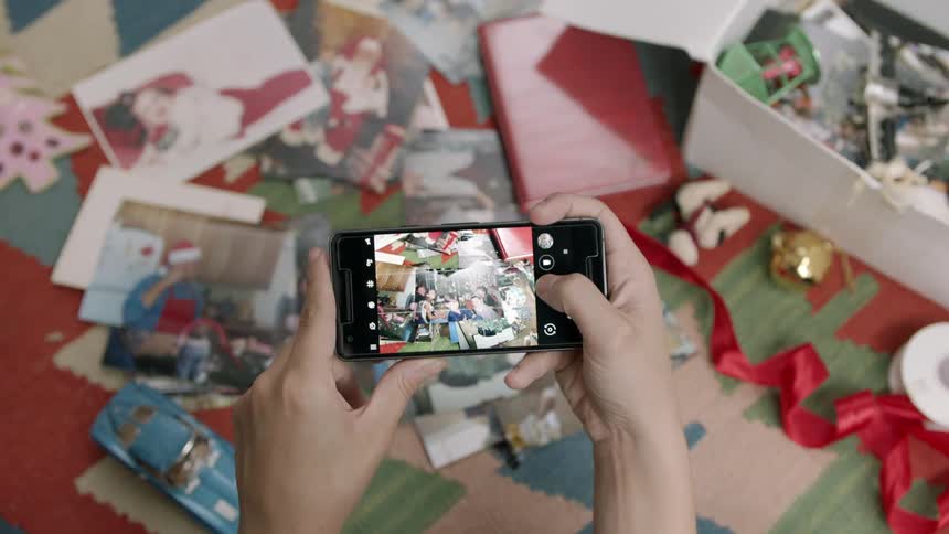 A person takes a photograph of some items on the ground