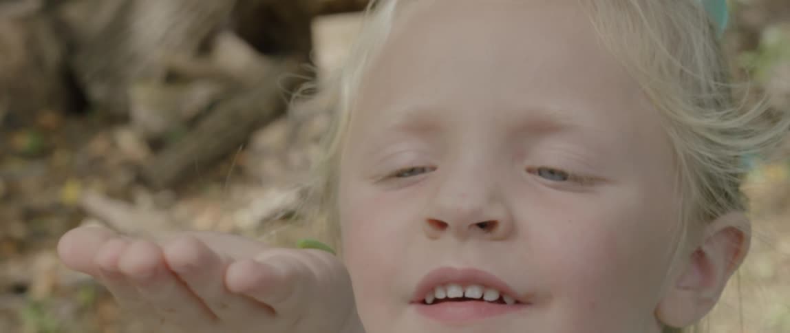 A child has a bug on her hand