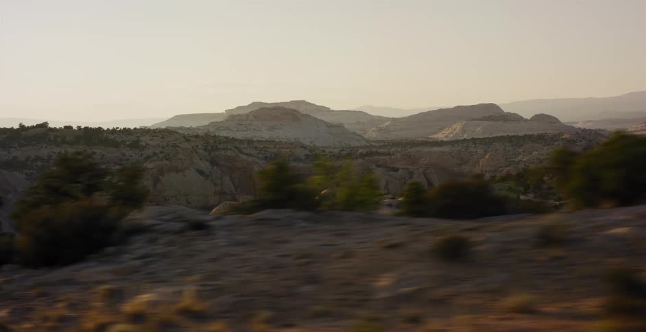A smooth tracking shot of a beautiful desert canyon landscape during golden hour