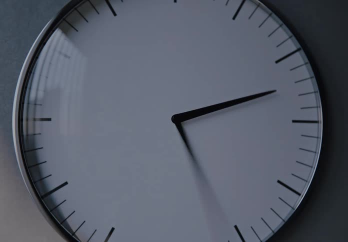 A time-lapse of a minimalist clock shows a full day passing as the light changes from dawn to dusk and fades to black