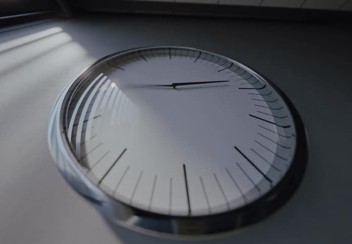 A dramatic timelapse shows the hands of a modern clock spinning rapidly as the light changes from day to night