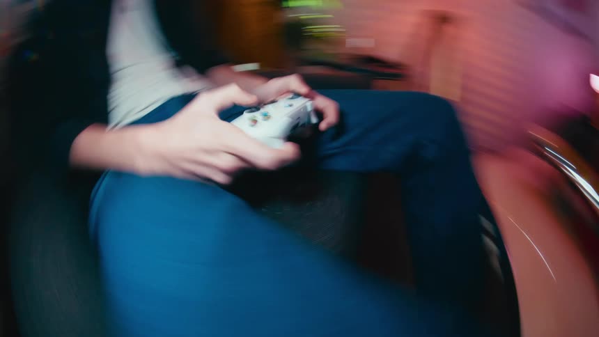 Dizzying first-person perspective shot of a person intensely playing a video game at home