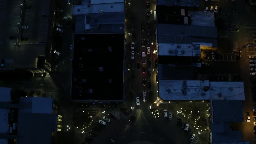 Cars are traveling on the roads below at night