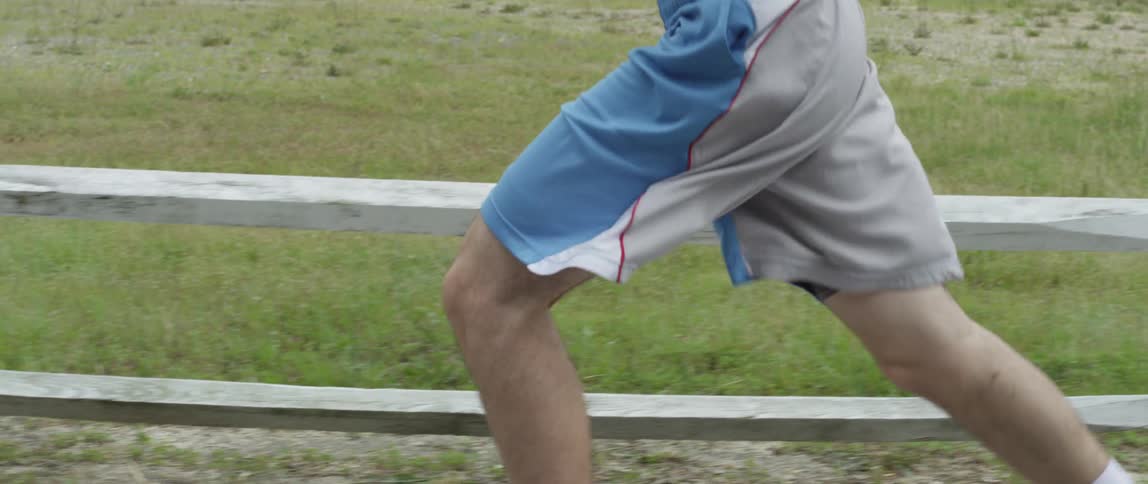 Man with tattoos running outside
