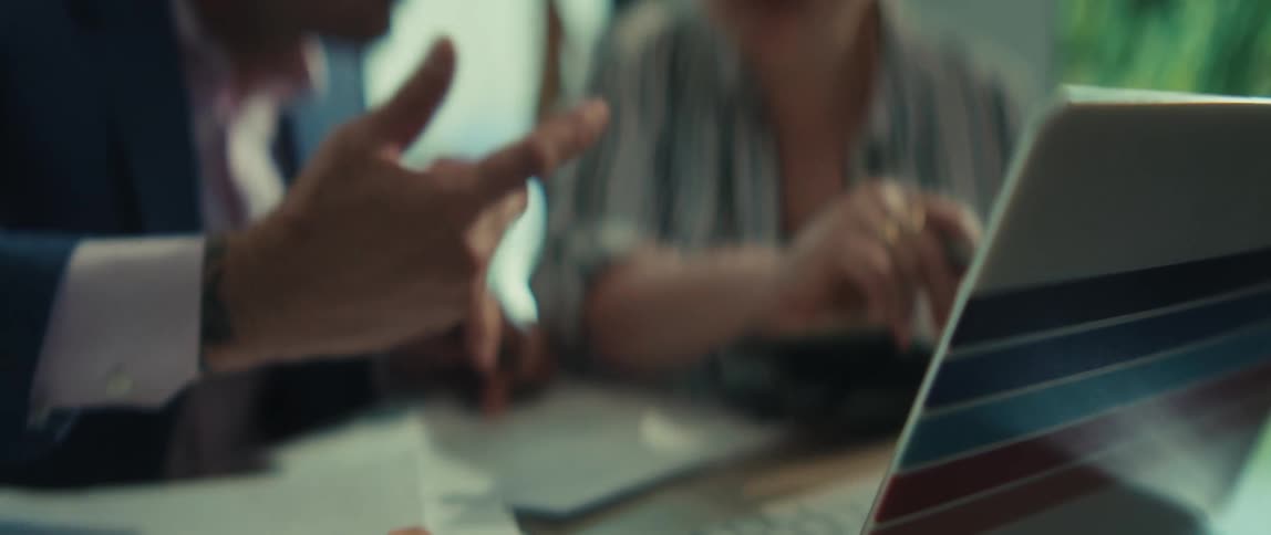 Soft focus close up on a businessman's hand as he points to a laptop screen during a collaborative meeting