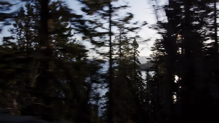Scenic drive along a mountain road with a breathtaking reveal of Emerald Bay in Lake Tahoe at sunset