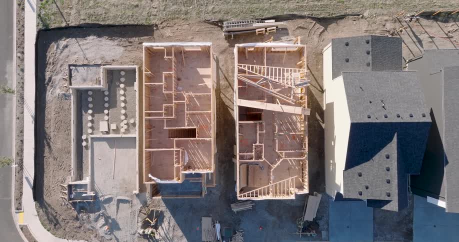 Steady rise high above new homes in various stages of construction in a new suburban development