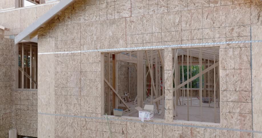 Pullback reveal of the exterior wood framing of a new townhouse under construction