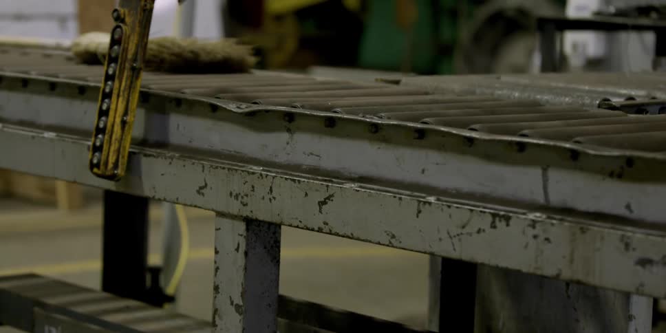 A hook hangs above an assembly line