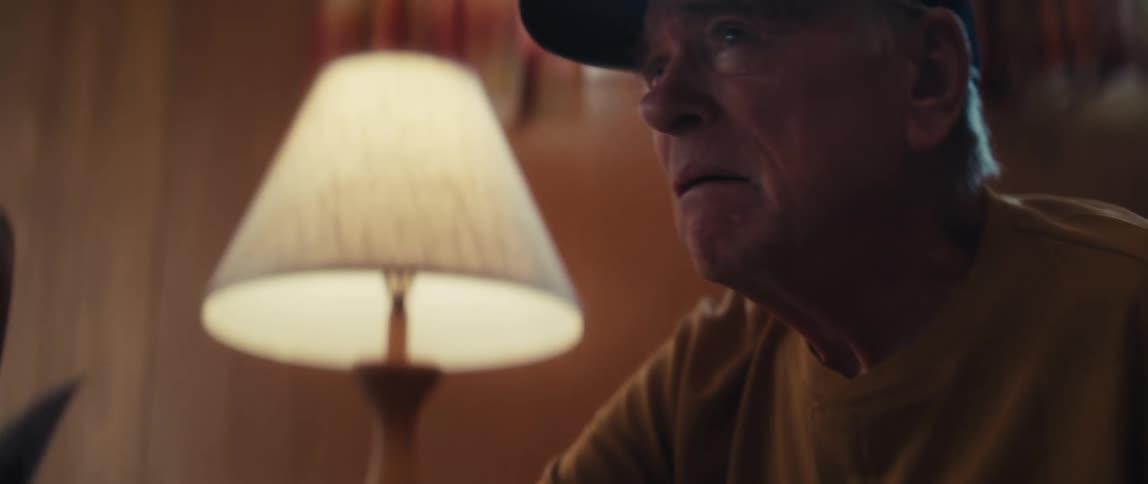 A concerned elderly Vietnam veteran looks at his brain scan results in a dimly lit room