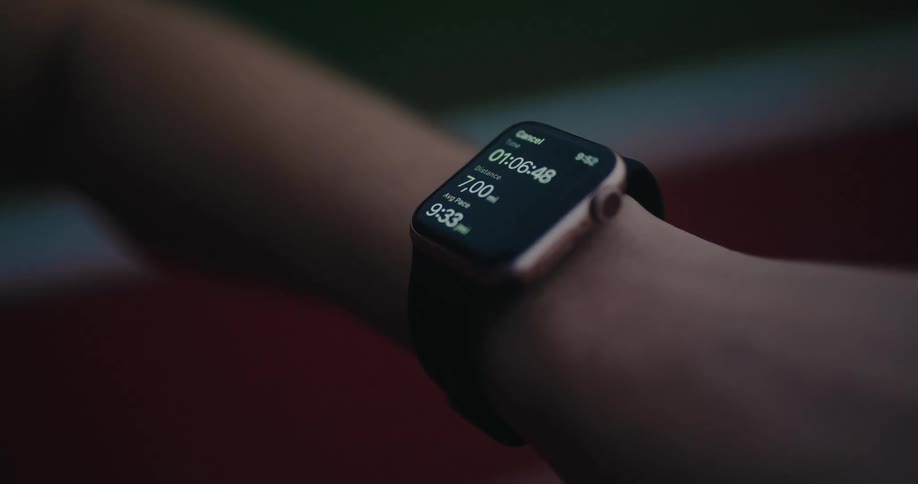 A runner checks their smartwatch, showing the completion of a 7-mile run with time and pace details