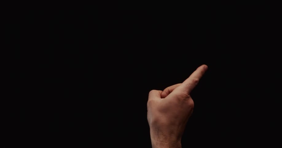 A man's hand wags its index finger in a gesture of disapproval against a solid black background