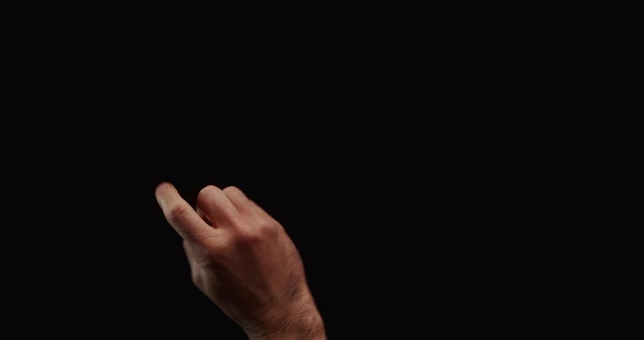 A man's hand rises from the bottom of the frame to give the middle finger against a black background
