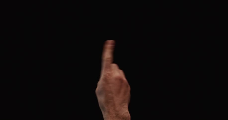 A man's hand wags an index finger back and forth in a disapproving gesture against a stark black background