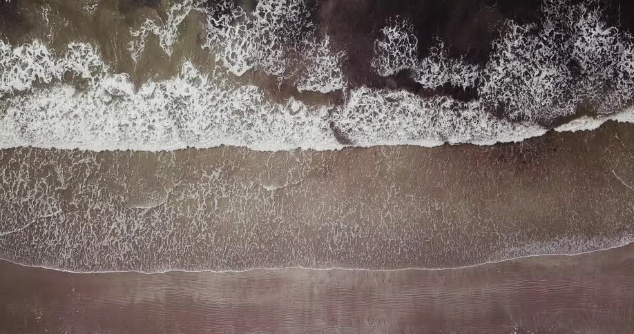 Waves hit the shore below