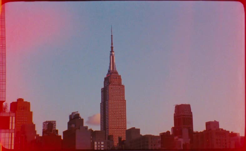 Iconic view of the Empire State Building on vintage super 8mm film with a film burn effect