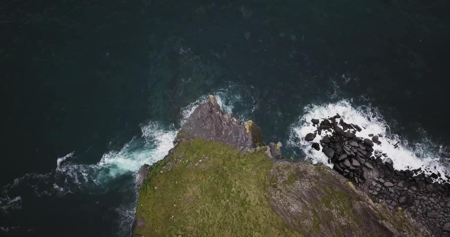 The sharp cliff goes into the water