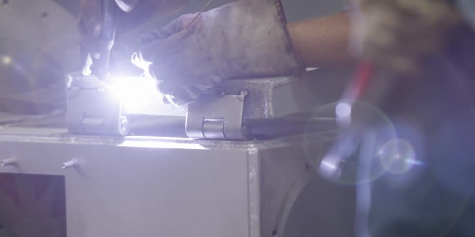 A welder works on a piece of metal