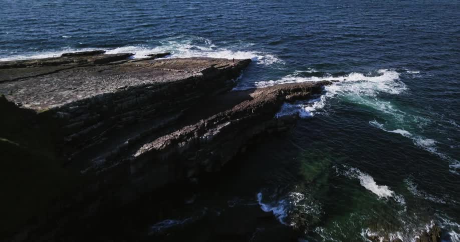 Waves crash against a rocky shore