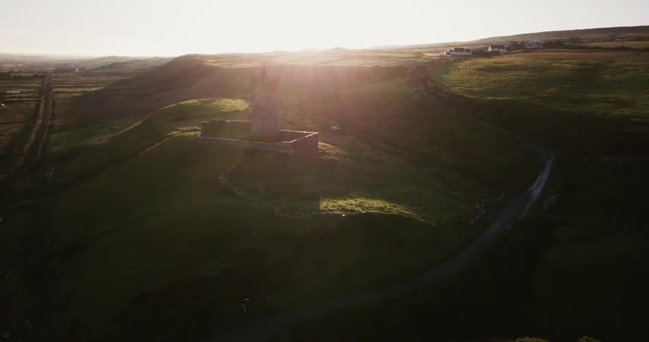 A tower sits on a hill at sunrise